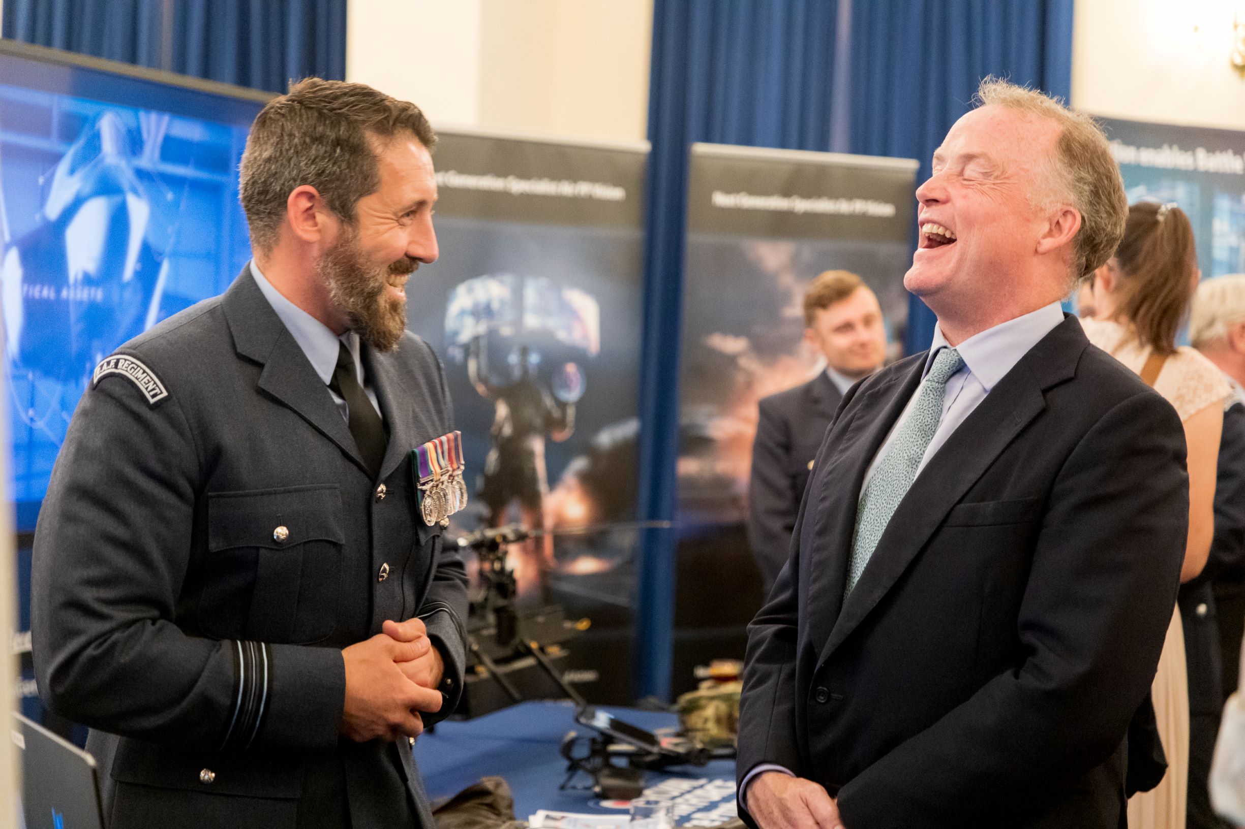Image shows aviators and guests laughing.